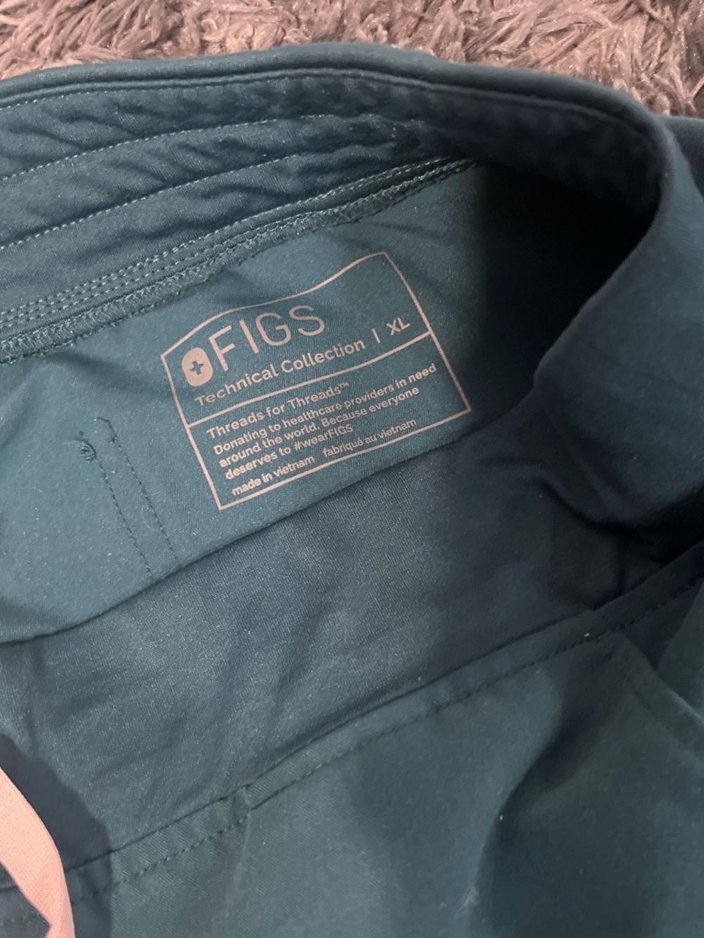FIGS Technical Collection Scrub Top in Deep Teal with Pink Label